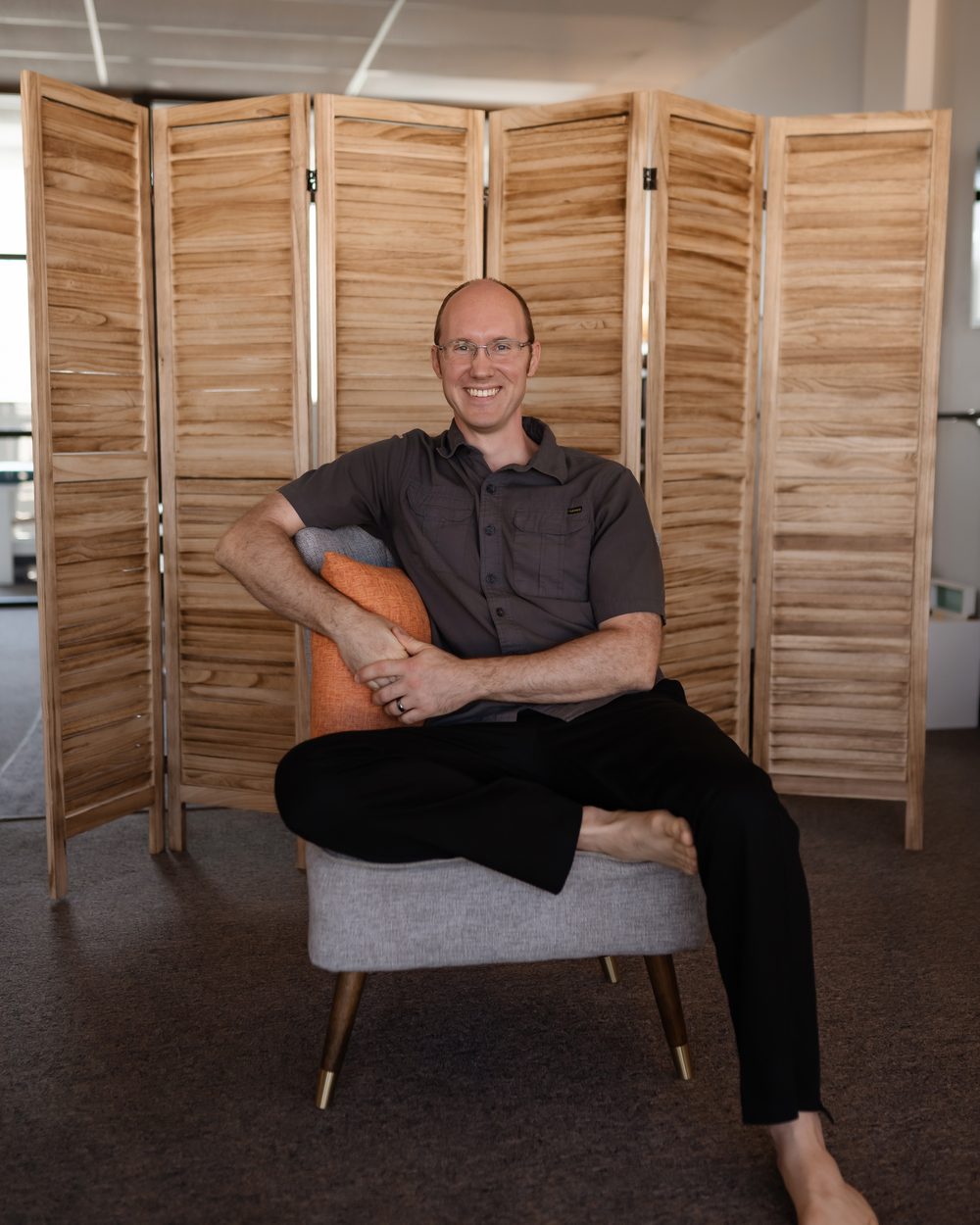 Dr. Jason Dixon, DC, seated in the Evolve Holistic Center office