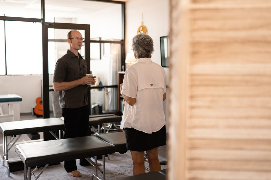 Dr. Jason in conversation with a practice member beside the care tables